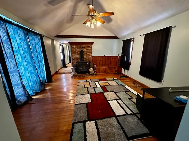 a living room with furniture rug and wooden floor