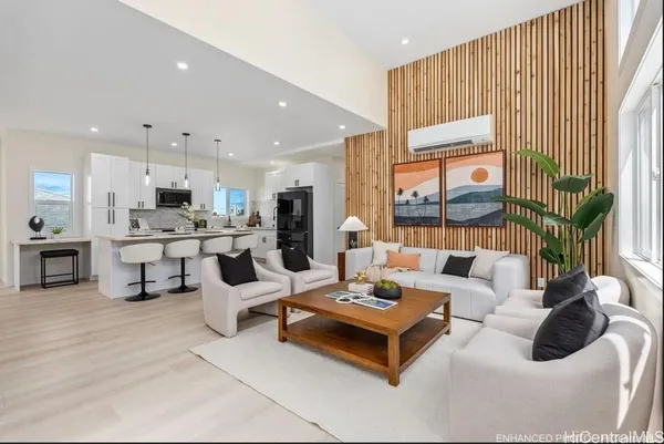 a living room with furniture kitchen view and a large window