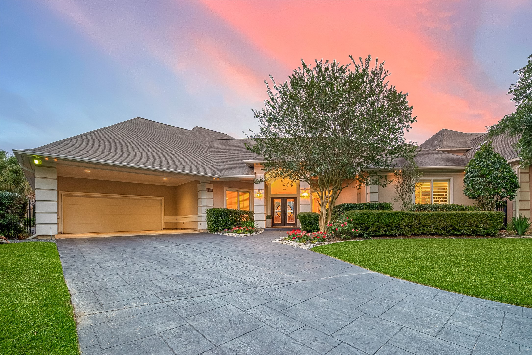 22 Stonegate Park Court Spring, TX 77379 - Photo 2 of 49 This home is nestled in a controlled access, gated subdivision and is situated in a cul-de-sac. It features manicured landscaping, gem stone lighting, a long, double-wide driveway with an extended roofline for additional covered parking.