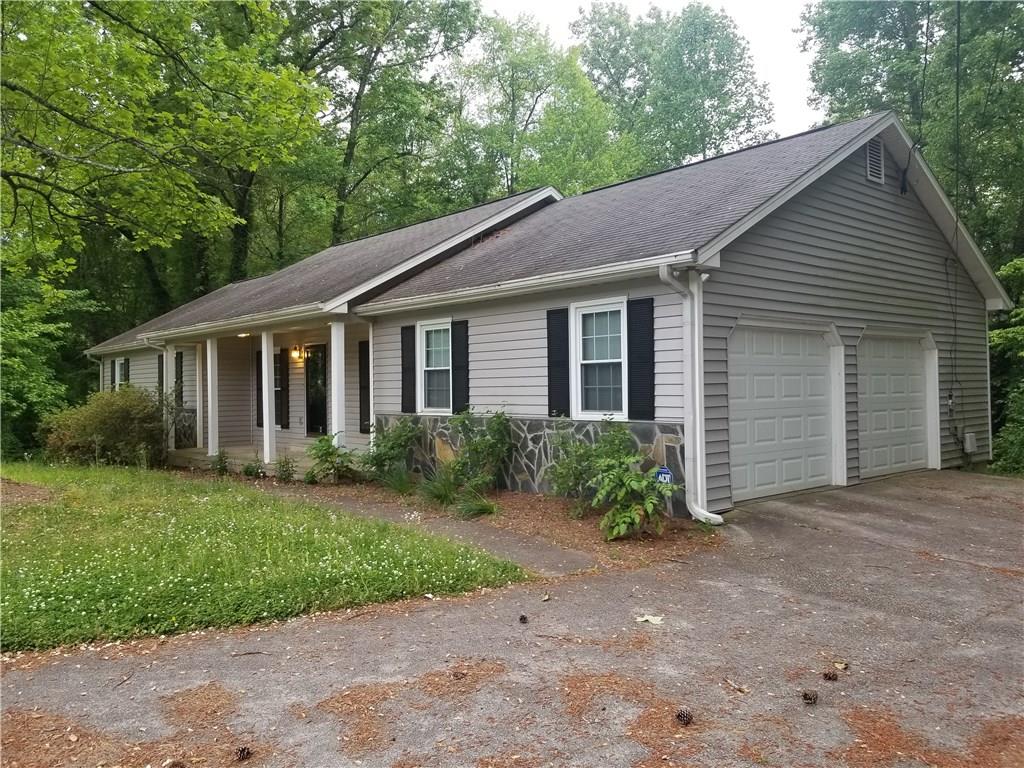 4586 Flint Hill Road Southwest Austell, GA 30106 - Photo 1 of 1 a front view of a house with garden