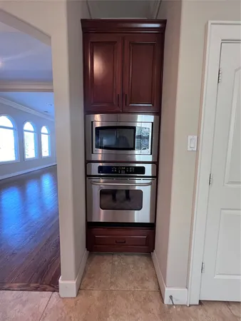 a stove top oven sitting inside of a kitchen