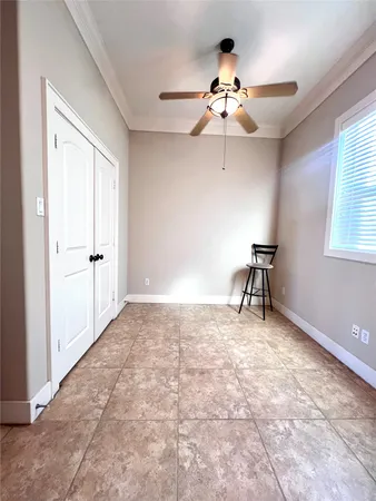 a view of a livingroom with a ceiling fan and a window