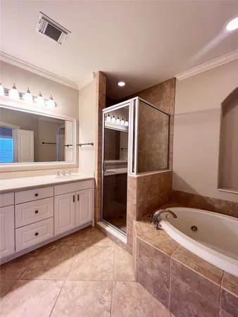 a bathroom with a bathtub sink and mirror