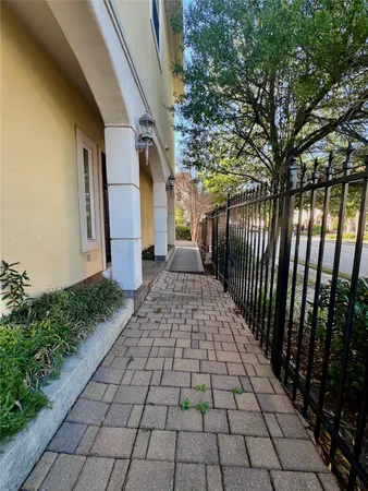 a view of a pathway with a wrought fence