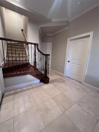 a view of a livingroom with entryway and stairs