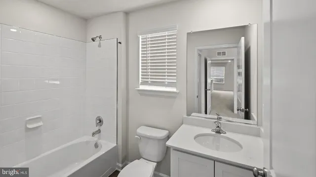 a bathroom with a double vanity sink mirror and shower