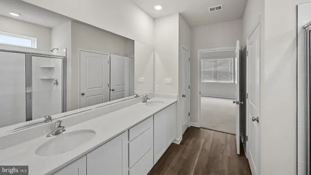 a bathroom with a glass shower door
