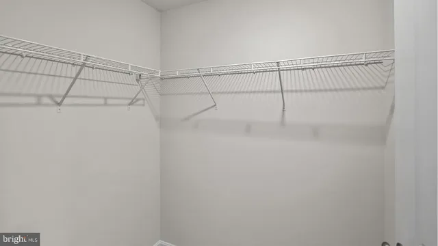 a view of hallway with stairs and wooden floor