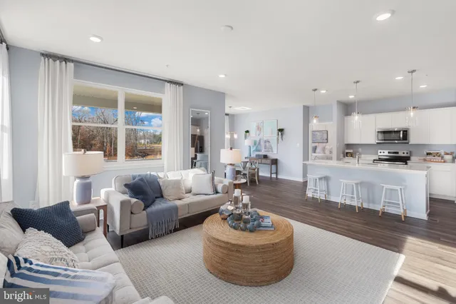 a living room with furniture kitchen and a table