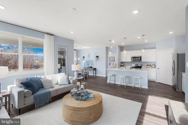 a kitchen with a center island appliances and cabinets