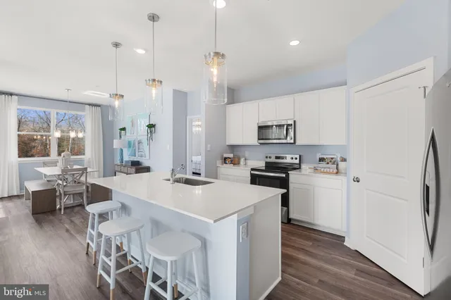 a kitchen with stainless steel appliances a stove sink microwave and cabinets