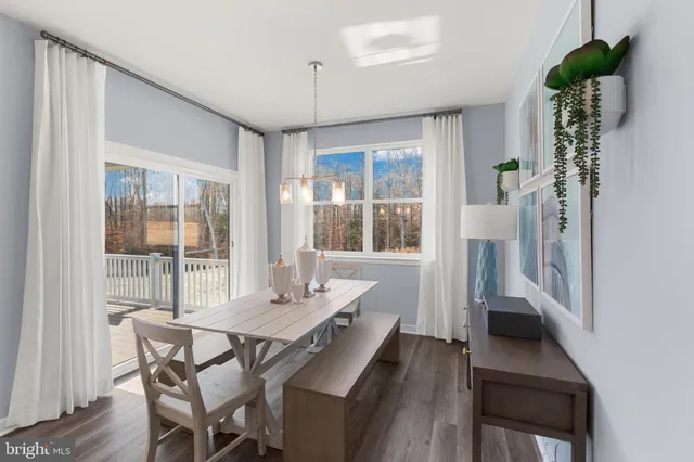 a bedroom with a large bed and a potted plant