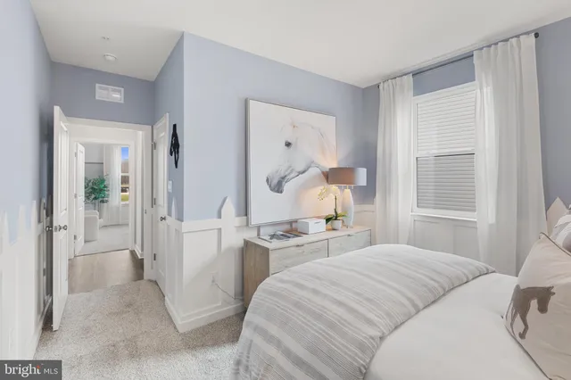 a view of a hallway with wooden floor and closet