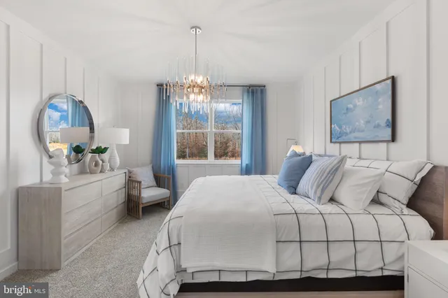 a bedroom with a large bed and a chandelier