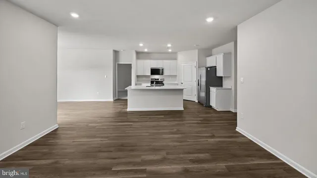 a view of a kitchen with a sink and cabinets