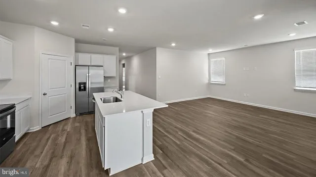 a kitchen with a refrigerator and cabinets