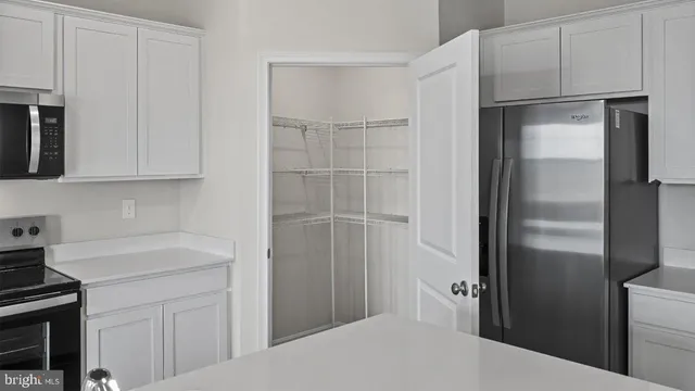 a kitchen with a refrigerator and a stove