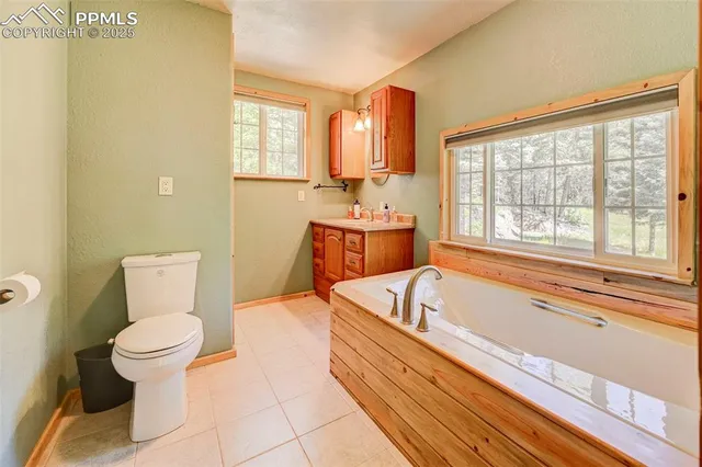 a bathroom with a tub sink and mirror