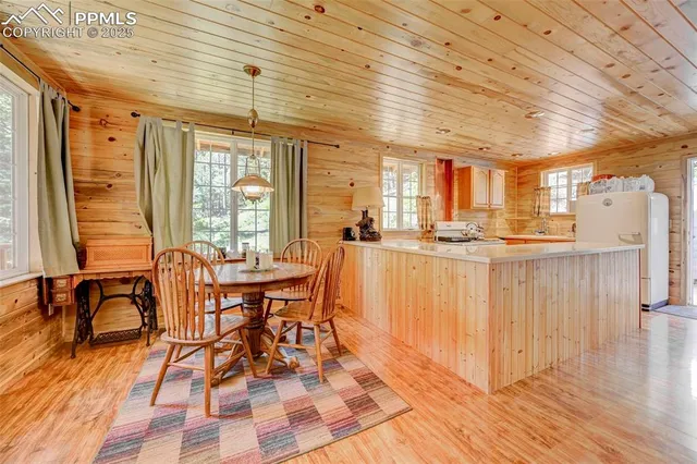 a kitchen with stainless steel appliances granite countertop a sink a stove and a refrigerator