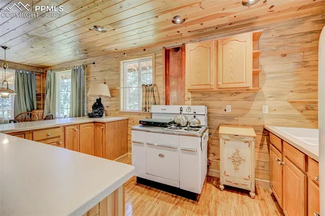 a kitchen with stainless steel appliances granite countertop a sink stove and wooden cabinets