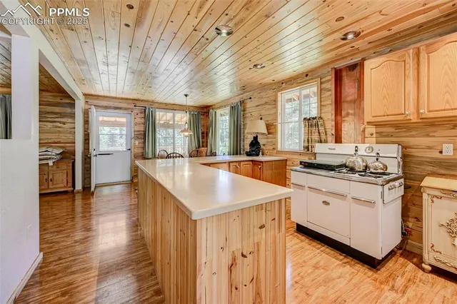 a large kitchen with cabinets a sink and a dishwasher