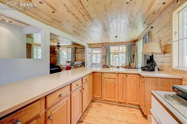 a view of kitchen with furniture and large windows