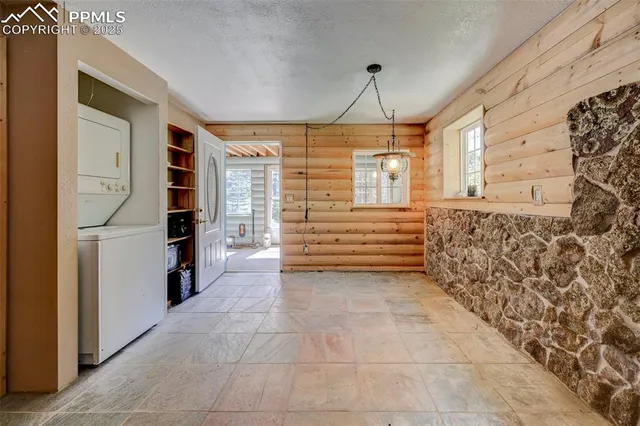 a view of entryway with a window and a chandelier