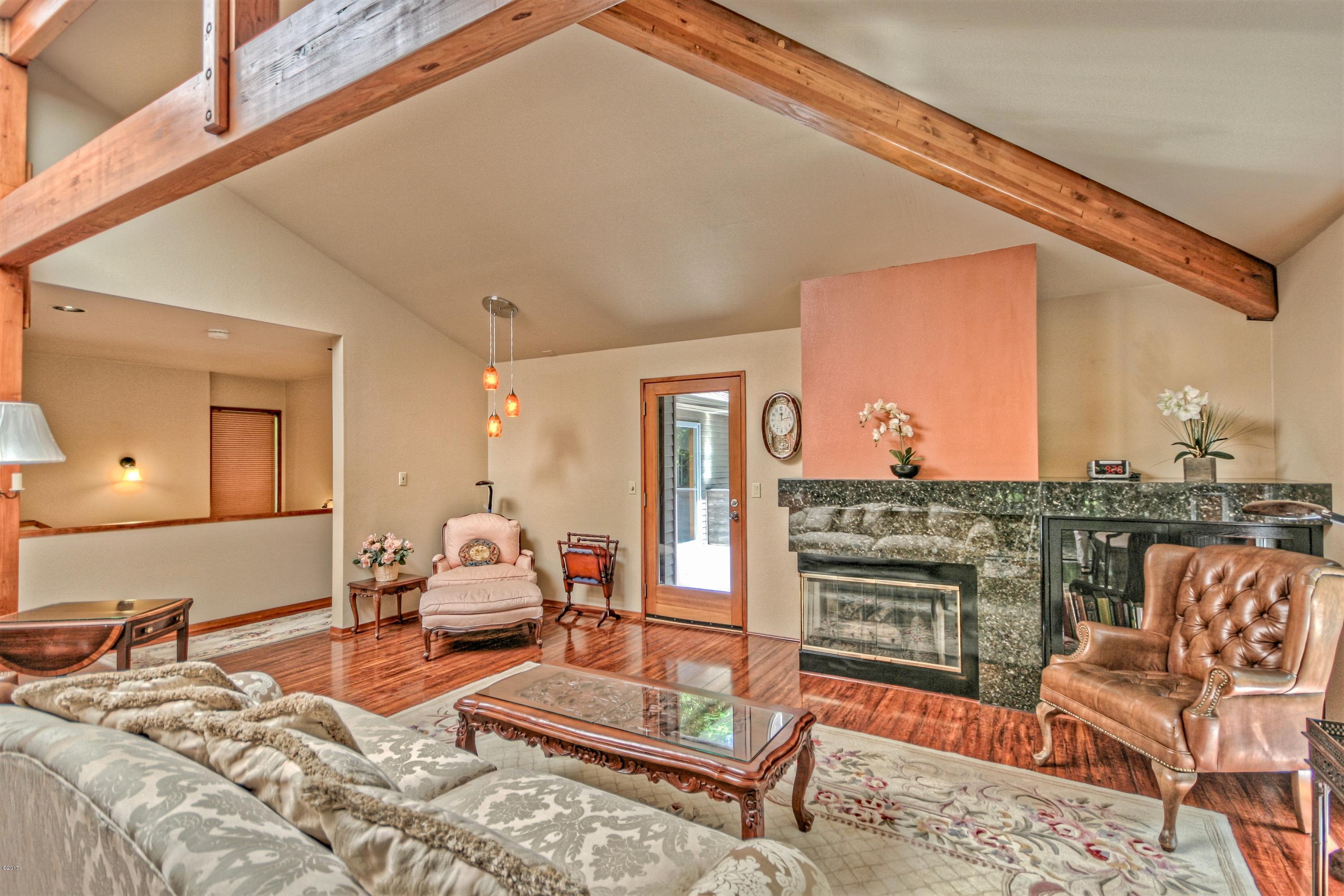 17 Big Tree Road Gleneden Beach, OR 97388 - Photo 4 of 52 a bedroom with furniture and a wooden floor