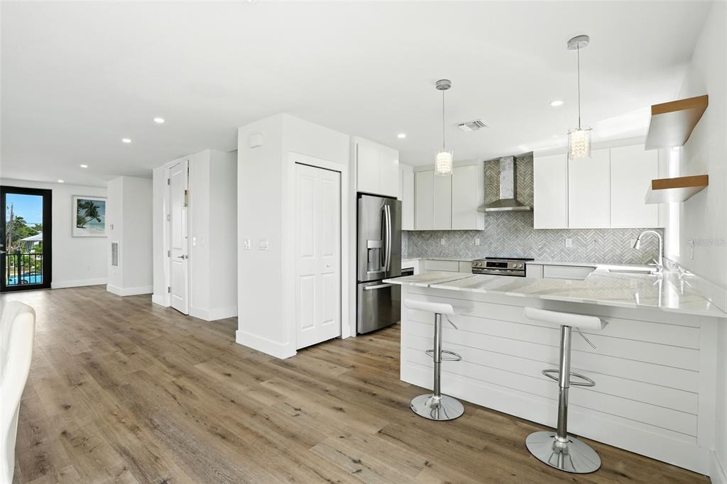 207 Shreve Street Punta Gorda, FL 33950 - Photo 11 of 45 a kitchen with a refrigerator a sink and white cabinets