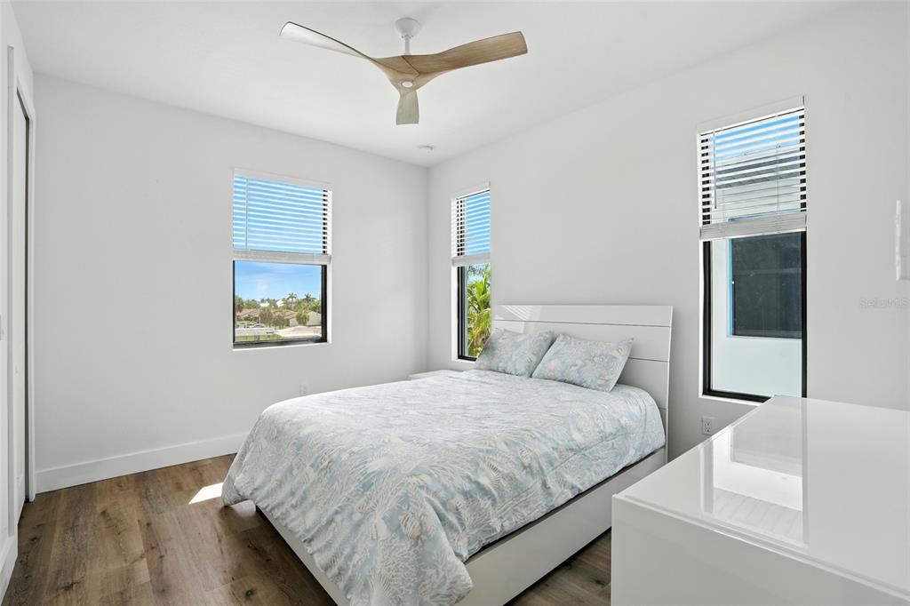 207 Shreve Street Punta Gorda, FL 33950 - Photo 29 of 45 a bedroom with a bed and a painting on the wall