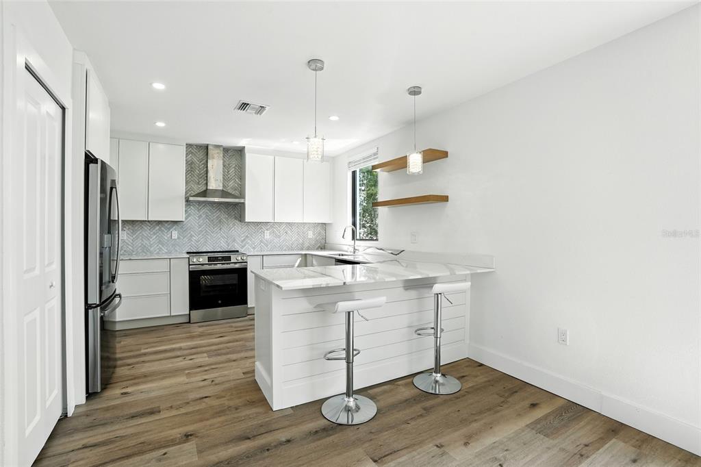 207 Shreve Street Punta Gorda, FL 33950 - Photo 10 of 45 a kitchen with a sink stainless steel appliances and cabinets