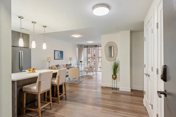 a view of a a dining room with furniture window and wooden floor