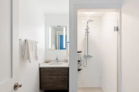 a bathroom with a shower and a sink