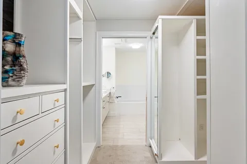 a bathroom with a granite countertop sink a toilet and shower