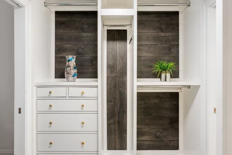 a bathroom with a double vanity sink mirror and bathtub
