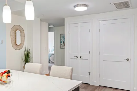 a spacious bedroom with a bed and a mirror