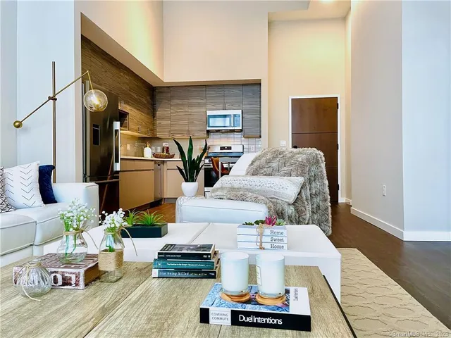 a living room with furniture and wooden floor