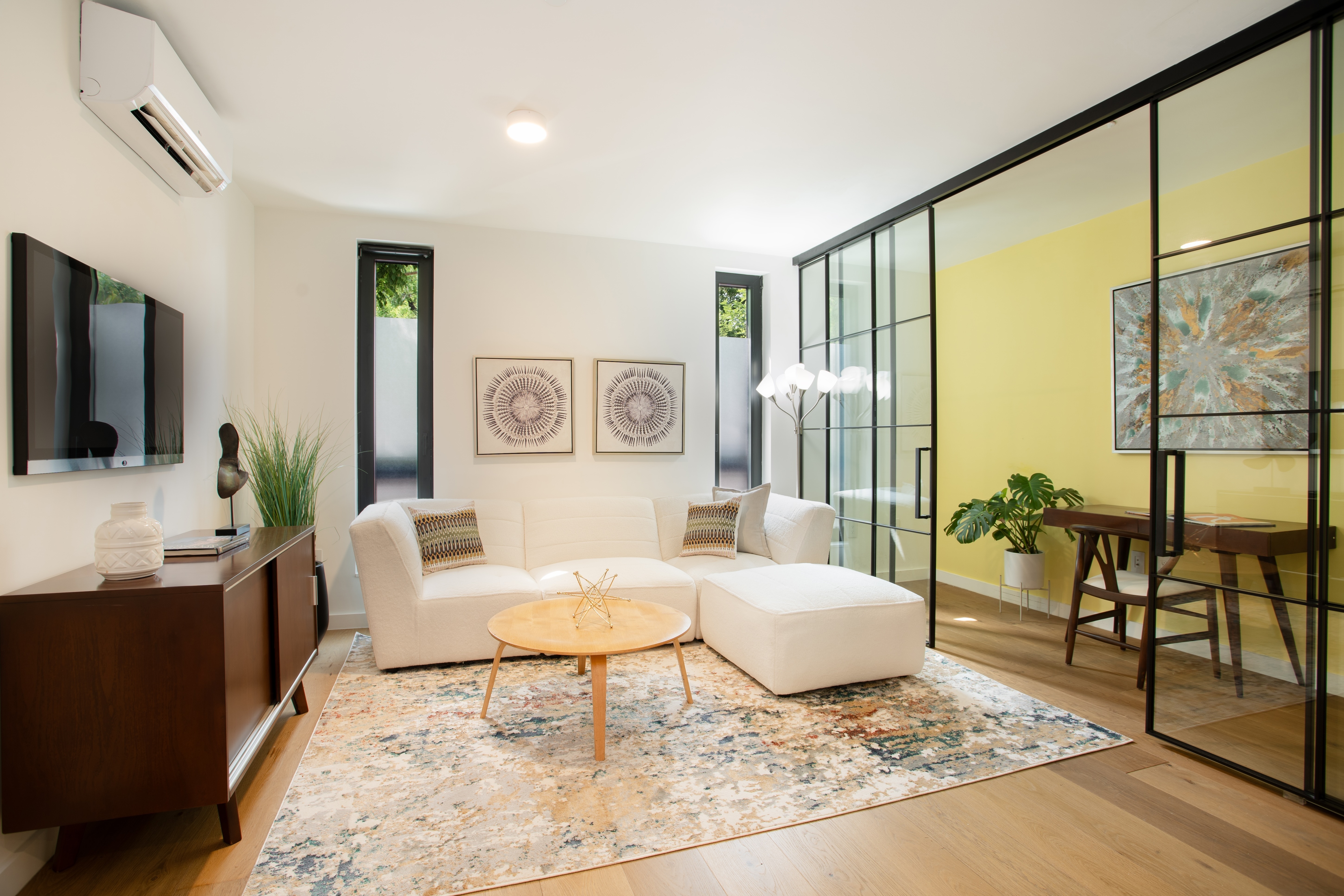 a living room with furniture and a flat screen tv