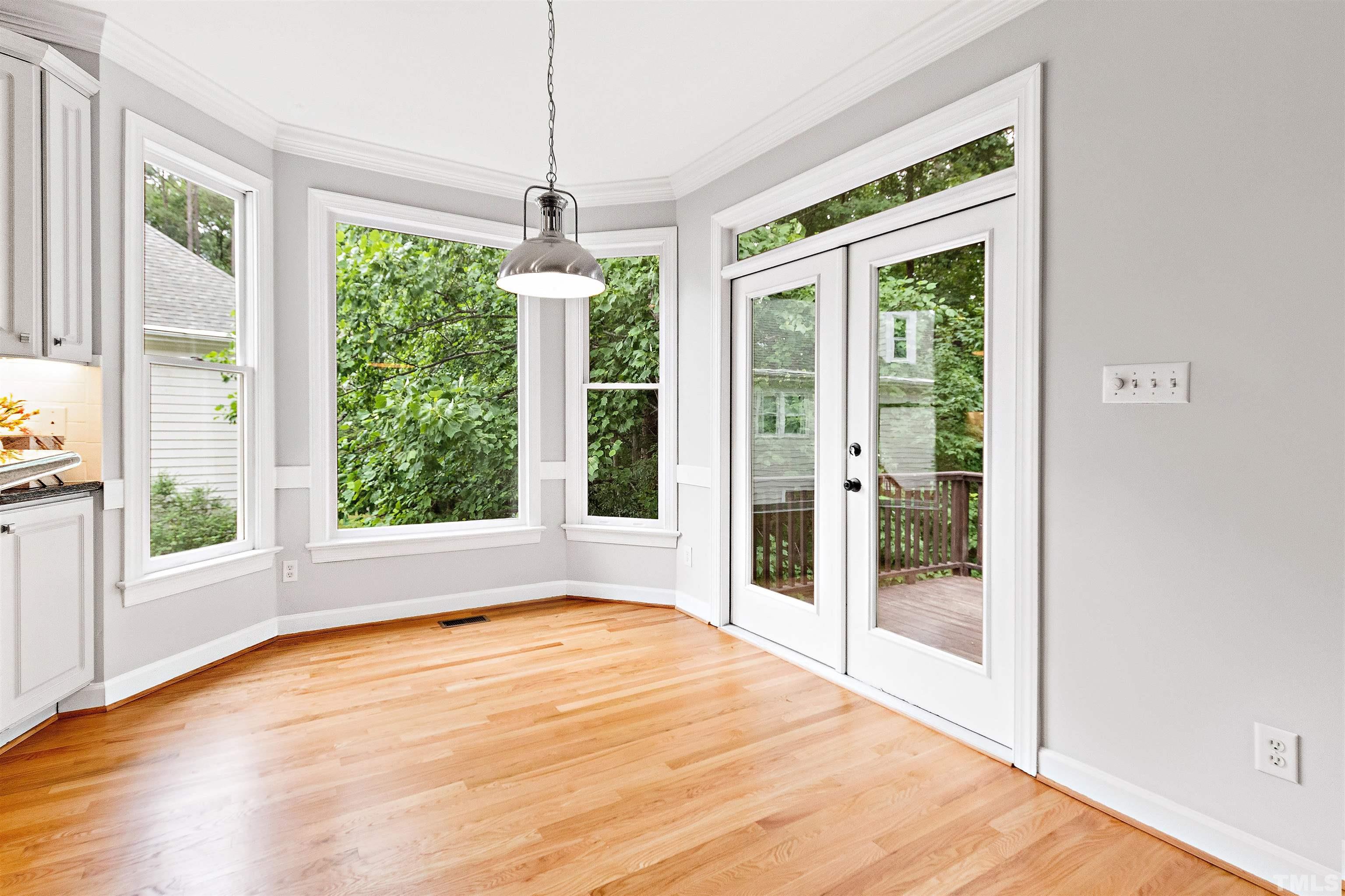 1912 Amity Hill Court Raleigh, NC 27612 - Photo 13 of 36 a view of an empty room with wooden floor and a window