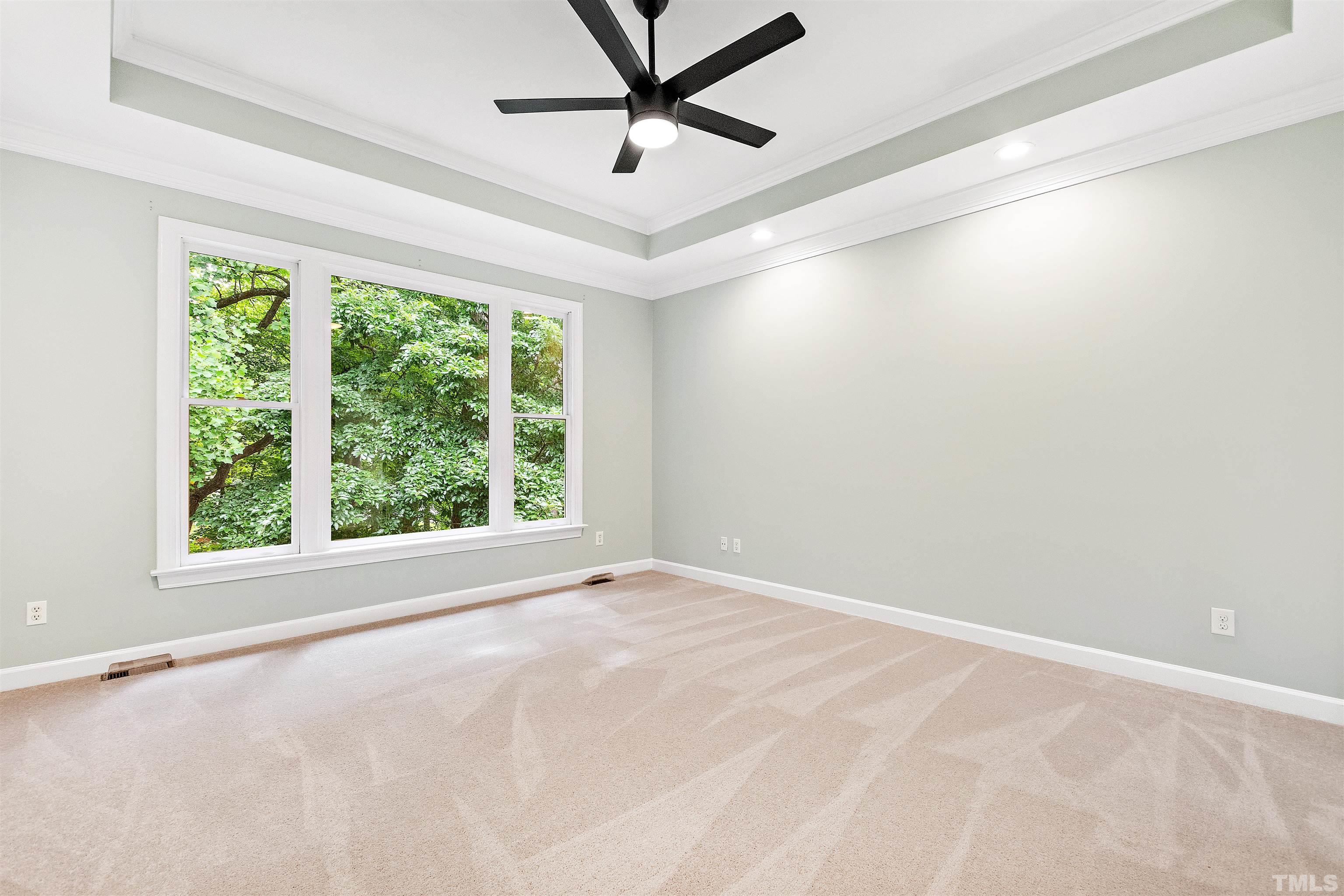 1912 Amity Hill Court Raleigh, NC 27612 - Photo 16 of 36 an empty room with a window and a fan