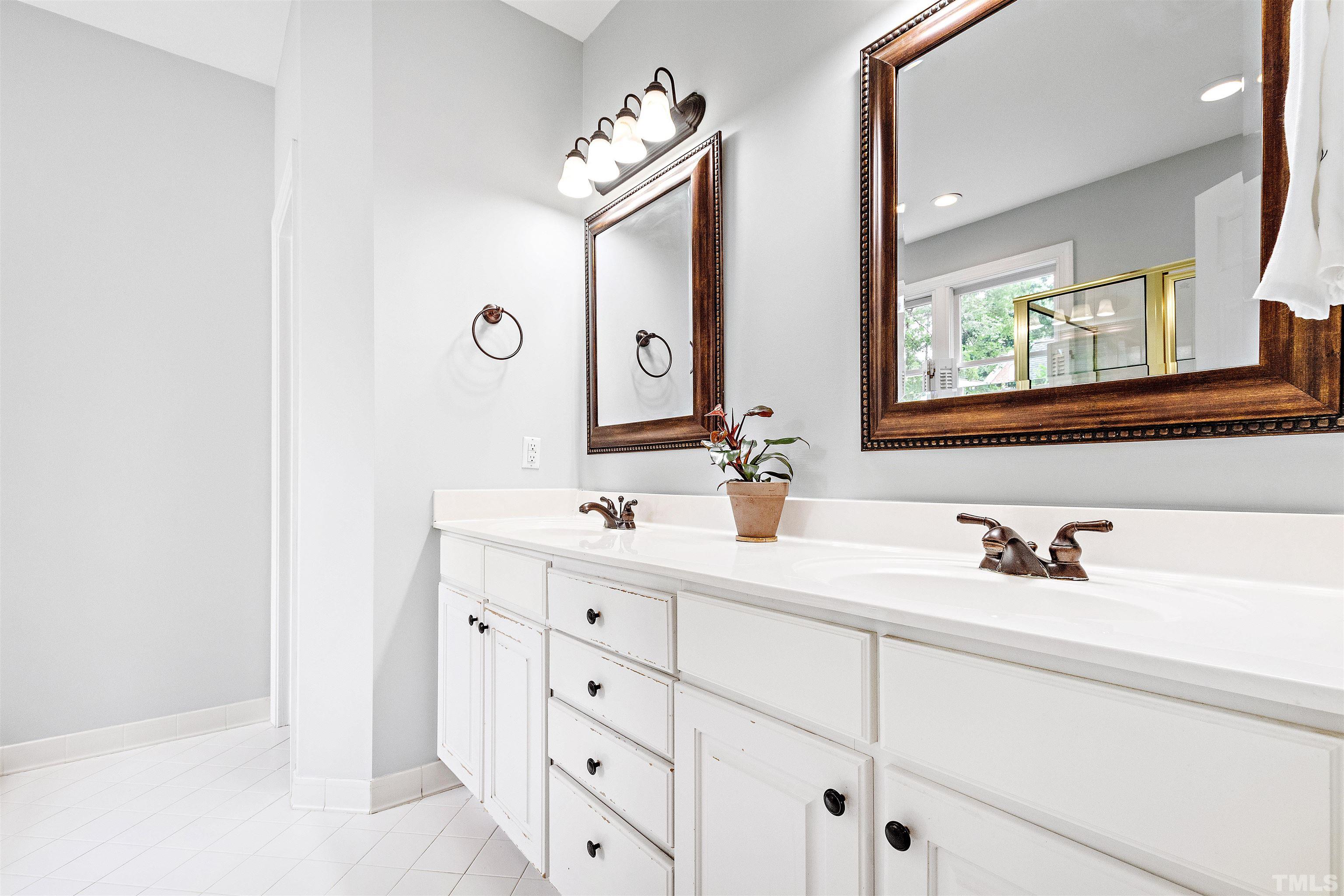 1912 Amity Hill Court Raleigh, NC 27612 - Photo 18 of 36 a bathroom with a double vanity sink mirror and