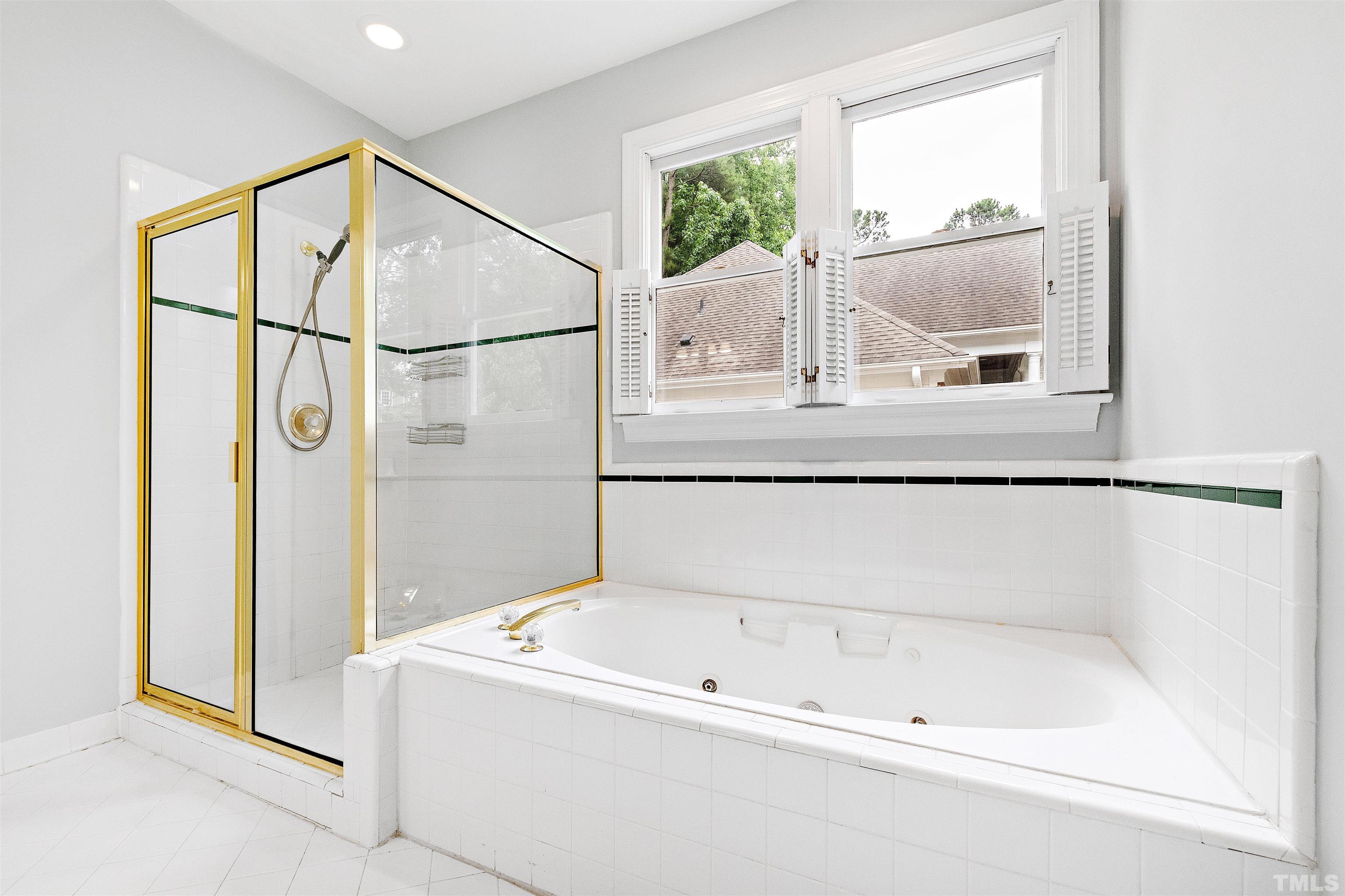 1912 Amity Hill Court Raleigh, NC 27612 - Photo 19 of 36 a bathroom with a bathtub and a window