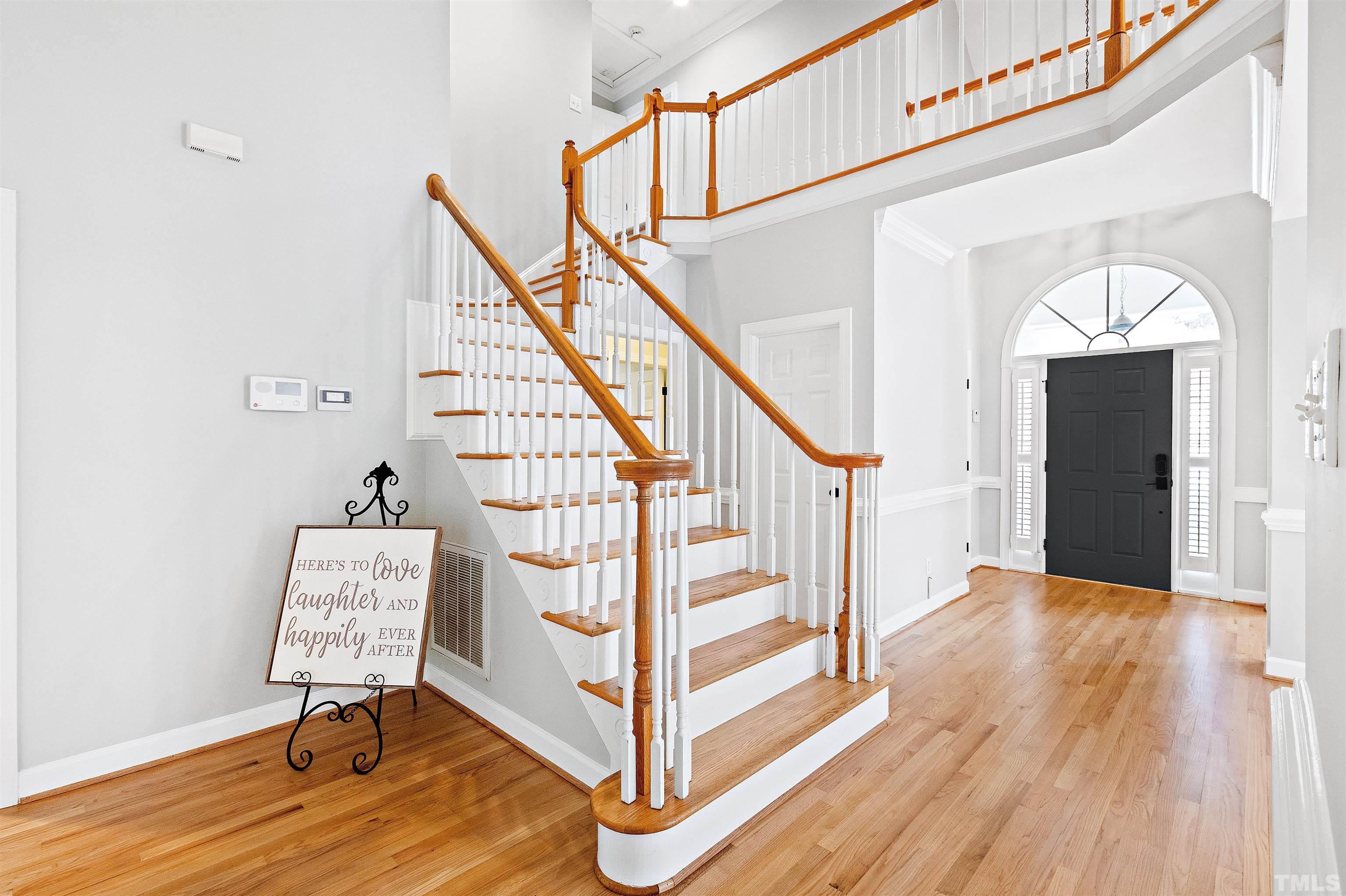 1912 Amity Hill Court Raleigh, NC 27612 - Photo 21 of 36 a view of front door with wooden floor and stairs