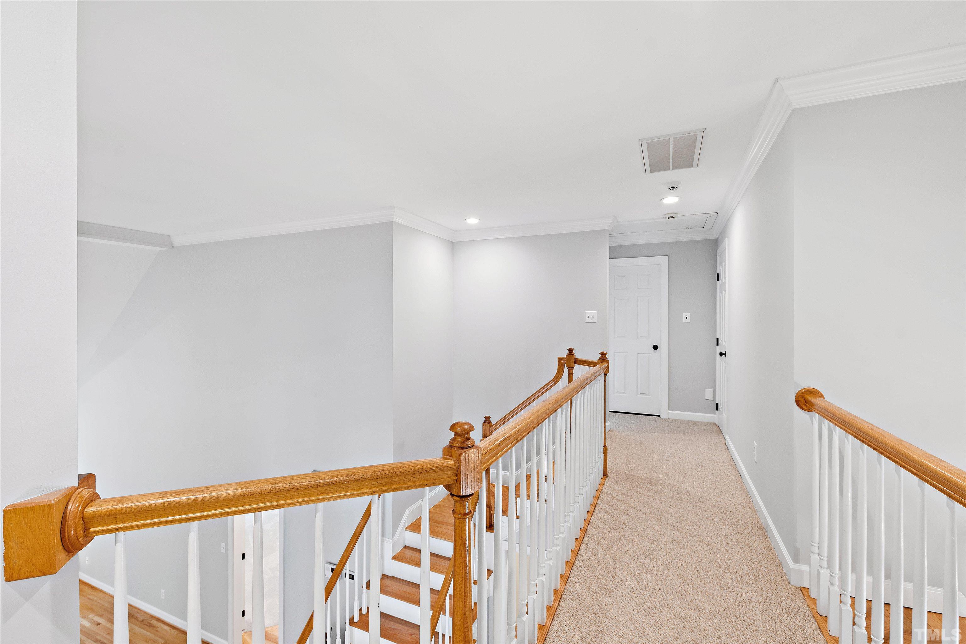 1912 Amity Hill Court Raleigh, NC 27612 - Photo 22 of 36 a view of a hallway with wooden floor and staircase