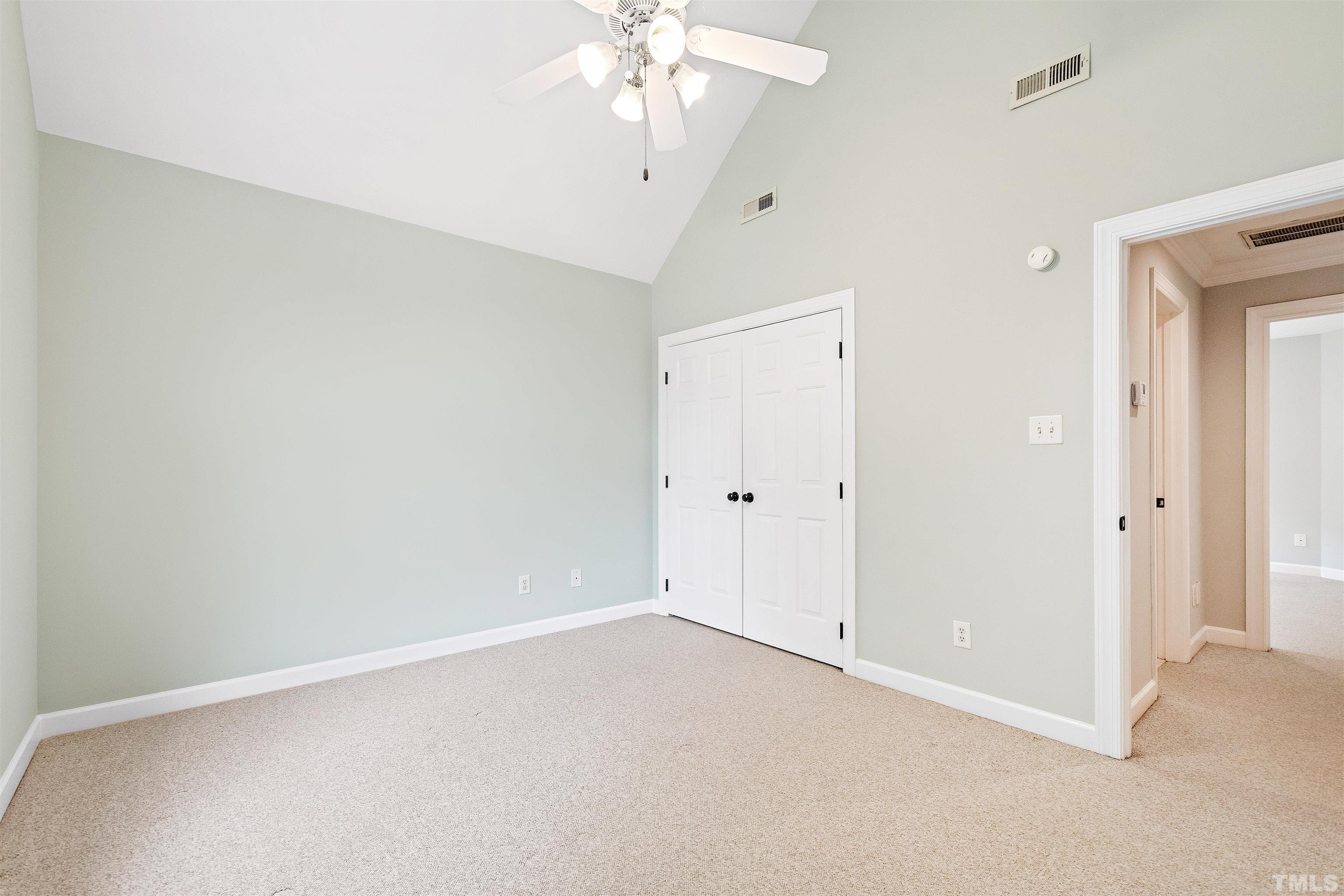 1912 Amity Hill Court Raleigh, NC 27612 - Photo 27 of 36 an empty room with a chandelier fan and a chandelier fan
