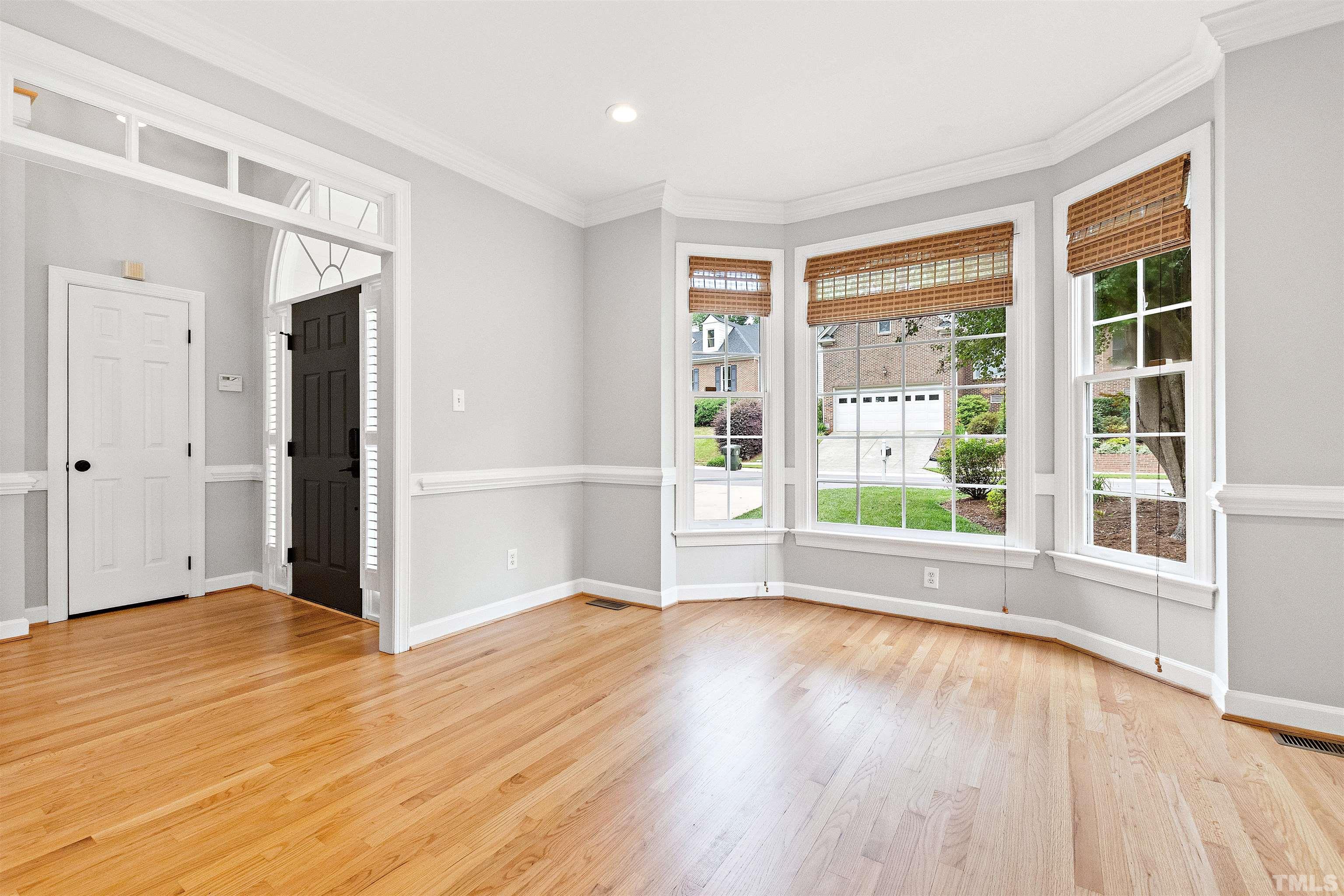 1912 Amity Hill Court Raleigh, NC 27612 - Photo 5 of 36 a view of an empty room with wooden floor and a window