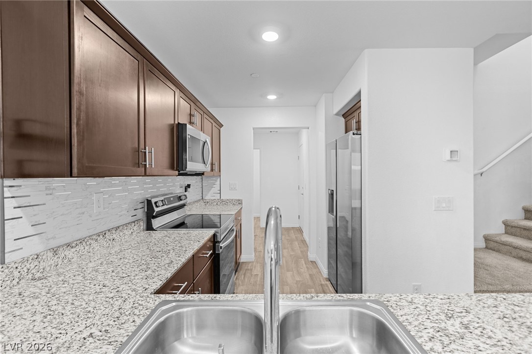 12367 Indigo Montage Road, Unit 3 Las Vegas, NV 89183 - Photo 5 of 33 This modern kitchen features elegant countertops, sleek appliances, and ample cabinet space.