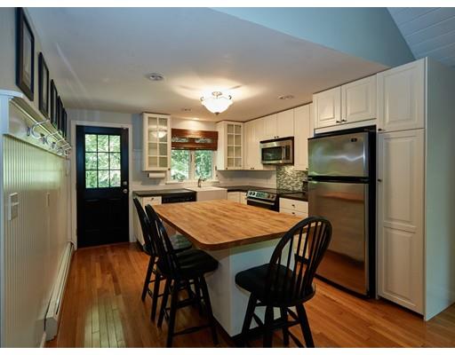 37 Stony Hollow Road Tiverton, RI 02878 - Photo 12 of 30 a kitchen with stainless steel appliances granite countertop a dining table chairs refrigerator and microwave