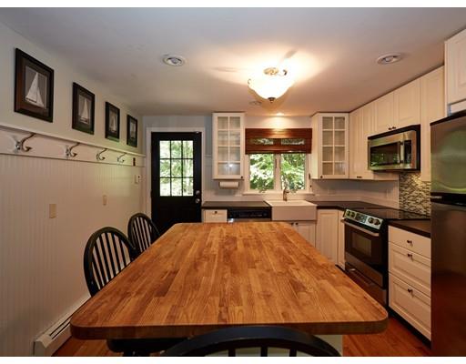 37 Stony Hollow Road Tiverton, RI 02878 - Photo 10 of 30 a open kitchen with stainless steel appliances granite countertop a stove top oven a sink dishwasher a dining table and chairs with wooden floor