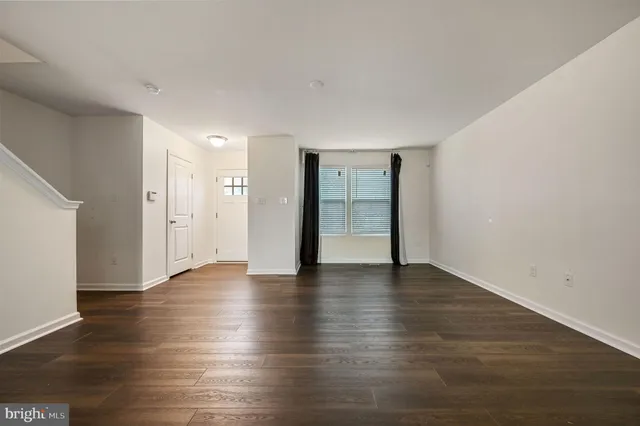 a view of an empty room and wooden floor